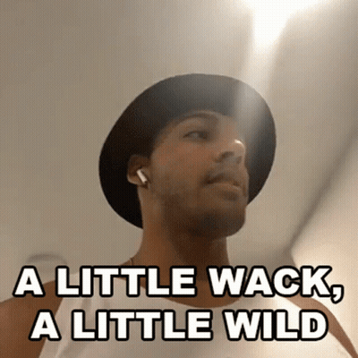 A Man Wearing A Hat And Earbuds Says A Little Wack A Little Wild GIF