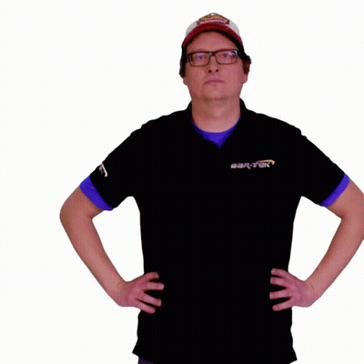 A Man Wearing A Hat And Glasses Holds A Cardboard Box In His Hand GIF