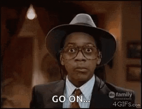 A Man Wearing A Hat And Glasses Is Making A Surprised Face And Saying `` Go On '' . GIF