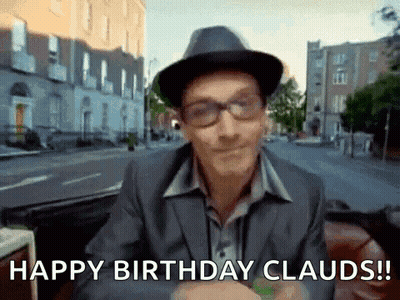 A Man Wearing A Hat And Glasses Is Saying Happy Birthday Clauds ! GIF