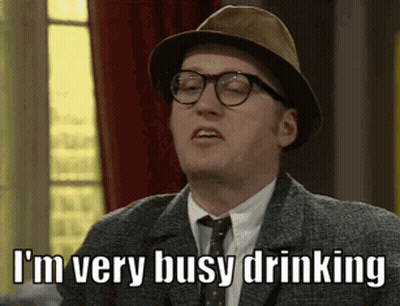 A Man Wearing A Hat And Glasses Is Saying I 'M Very Busy Drinking GIF