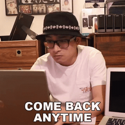 A Man Wearing A Hat And Glasses Sits In Front Of A Laptop With The Words Come Back Anytime Written On The Screen GIF