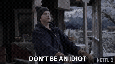 A Man Wearing A Hat And Gloves Says " Don 'T Be An Idiot " GIF