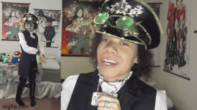 A Man Wearing A Hat And Goggles Is Standing In Front Of A Poster That Says ' Tokyo Ghoul ' On It GIF