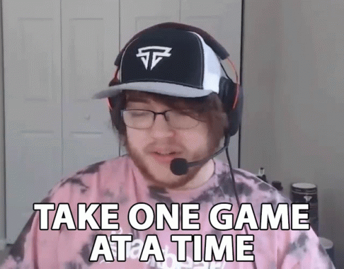 A Man Wearing A Hat And Headphones Is Saying Take One Game At A Time GIF