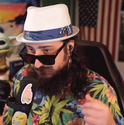 A Man Wearing A Hat And Sunglasses Has A Sticker On His Shirt That Says Spongebob GIF