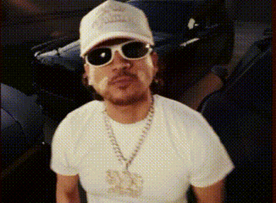 A Man Wearing A Hat And Sunglasses Is Standing In Front Of A Car .. GIF