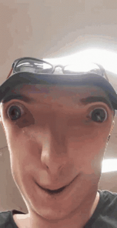 A Man Wearing A Hat And Sunglasses Making A Funny Face . GIF