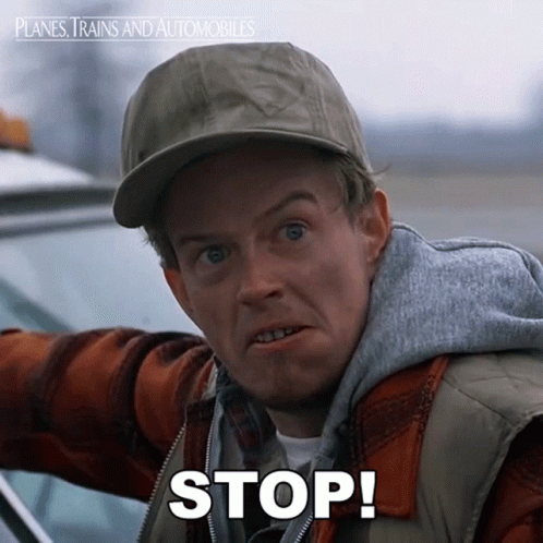 A Man Wearing A Hat And Vest Says " Stop " GIF