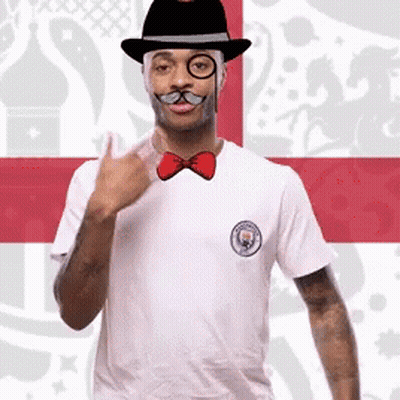 A Man Wearing A Hat Glasses And A Bow Tie GIF