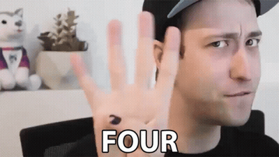 A Man Wearing A Hat Is Giving The Number Four With His Hand GIF