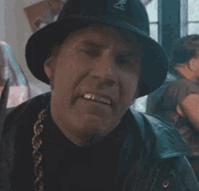 A Man Wearing A Hat Is Holding A Knife To His Face . GIF