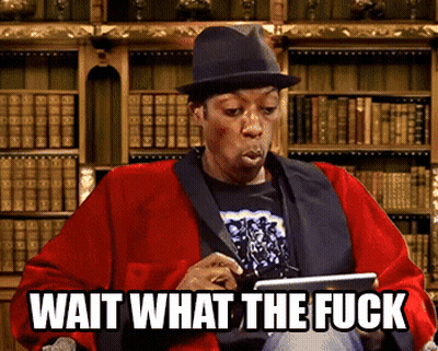 A Man Wearing A Hat Is Holding A Tablet With The Words Wait What The Fuck Below Him GIF
