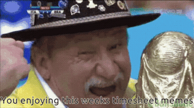 A Man Wearing A Hat Is Holding A Trophy With The Words You Enjoying This Weeks Timesheet Memes Below Him GIF