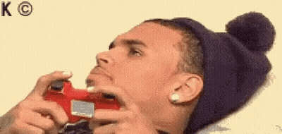 A Man Wearing A Hat Is Playing A Video Game . GIF