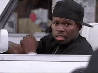 A Man Wearing A Hat Is Sitting In A Car And Looking Out The Window . GIF