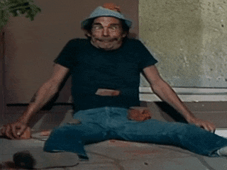 A Man Wearing A Hat Is Sitting On The Floor GIF