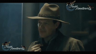 A Man Wearing A Hat Is Standing In Front Of A Sign That Says ' Pandill Aventurer ' GIF