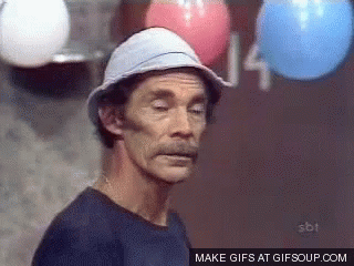 A Man Wearing A Hat Is Standing In Front Of Balloons With The Number 14 Written On The Wall Behind Him GIF