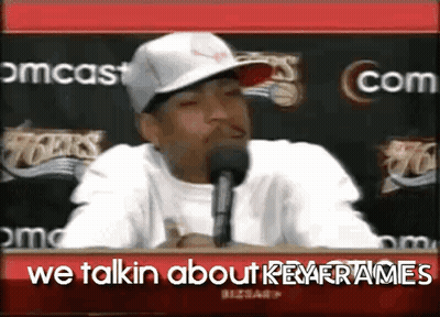A Man Wearing A Hat Is Talking Into A Microphone With The Words We Talkin About Key Frames Below Him GIF