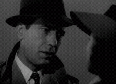 A Man Wearing A Hat Looks At A Woman Wearing A Hat GIF