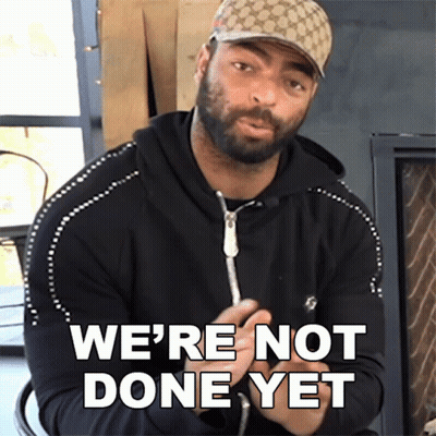 A Man Wearing A Hat Says " We 'Re Not Done Yet " In Front Of A Fireplace GIF