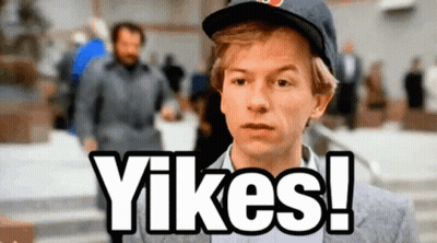 A Man Wearing A Hat Says " Yikes " In Front Of A Crowd GIF