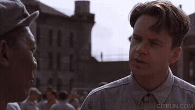 A Man Wearing A Hat Talks To Another Man With A Gifrun.com Watermark GIF