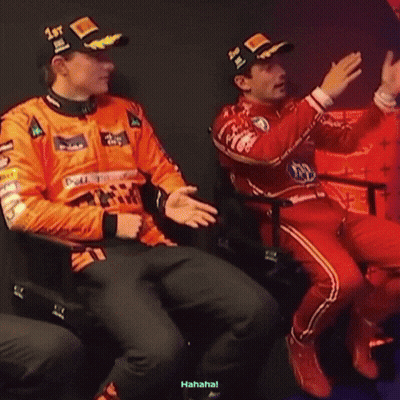 A Man Wearing A Hat That Says 1St Is Sitting Next To Another Man GIF