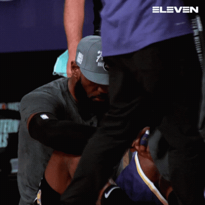 A Man Wearing A Hat That Says Finals Is Kneeling Down GIF