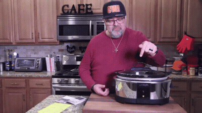 A Man Wearing A Hat That Says Grill Is Standing In Front Of A Stove In A Kitchen GIF