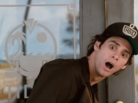 A Man Wearing A Hat That Says Hds Is Standing In Front Of A Glass Door . GIF