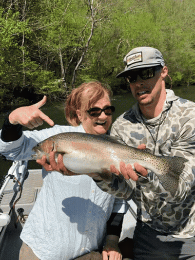 A Man Wearing A Hat That Says Hooker On It Holds A Large Fish GIF