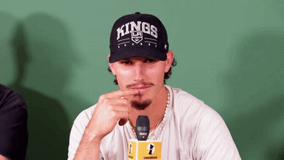 A Man Wearing A Hat That Says Kings Is Sitting In Front Of A Microphone GIF