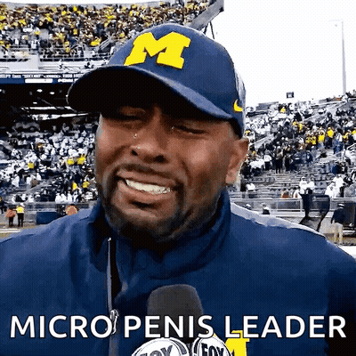 A Man Wearing A Hat That Says M On It GIF