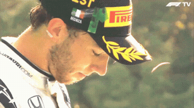 A Man Wearing A Hat That Says Monza GIF