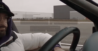 A Man Wearing A Hat That Says ' Nl ' On It Driving A Car GIF
