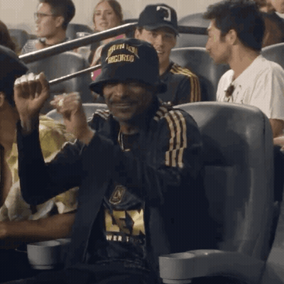 A Man Wearing A Hat That Says " Snoop Dogg " On It GIF