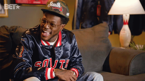 A Man Wearing A Hat That Says South Is Laughing GIF