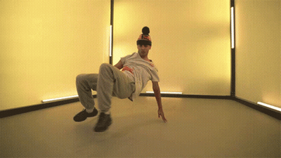 A Man Wearing A Hat That Says ' Supreme ' On It Is Doing A Trick GIF