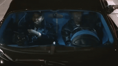 A Man Wearing A Hat That Says Xbok Is Sitting In A Car GIF