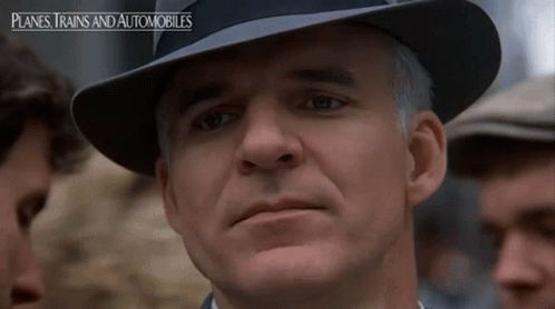 A Man Wearing A Hat With Planes Trains And Automobiles On The Bottom GIF