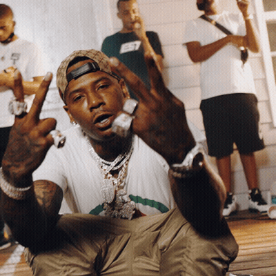 A Man Wearing A Hat With The Letter E7 On It Is Giving The Middle Finger GIF