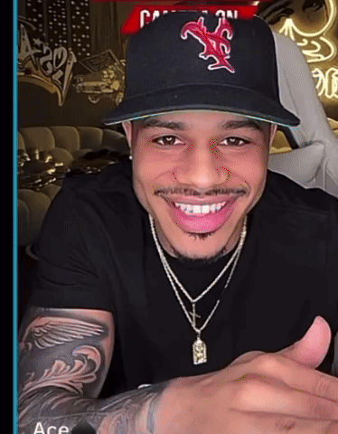 A Man Wearing A Hat With The Letter M On It Smiles GIF