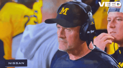 A Man Wearing A Hat With The Letter M On It Watches A Game GIF