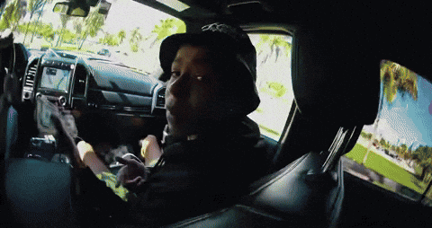 A Man Wearing A Hat With The Letter O On It Is Sitting In A Car GIF