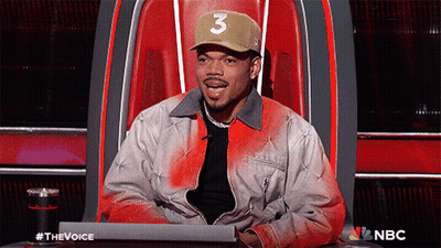 A Man Wearing A Hat With The Number 3 On It Is Sitting In A Chair GIF