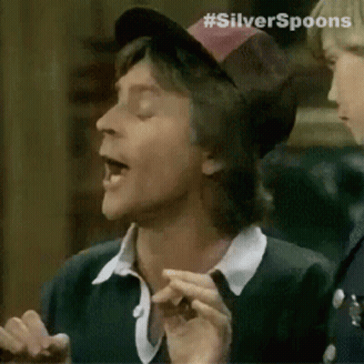 A Man Wearing A Hat With The Word Silver Spoons On It . GIF