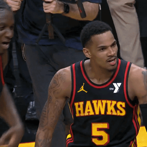A Man Wearing A Hawks Jersey Number 5 GIF