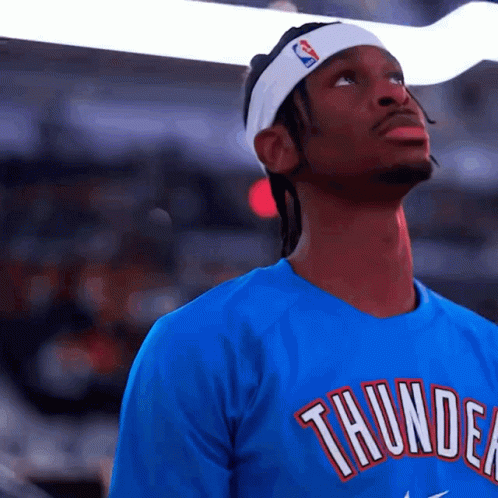 A Man Wearing A Headband And A Thunder Shirt GIF
